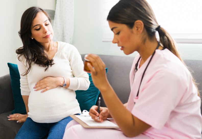 Medical Professional Talking to Pregnant Woman